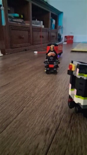 the Lego 60337 passenger train crosses to the Lego Hogwarts Express