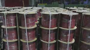 Coils with cables in the warehouse of the enterprise, finished cable products are neatly placed in a row