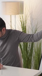 Vertical video. Statistics presentation. Data analytics. Business call. Man introducing financial graphs explaining charts on whiteboard at laptop meeting at office workplace.