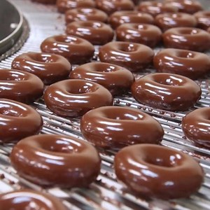 Chocolate Glazed doughnuts are rolling hot off the line! Only available until Tuesday 10th July so get in quick! | Krispy Kreme New Zealand