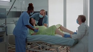 Screaming woman giving birth to child at maternity