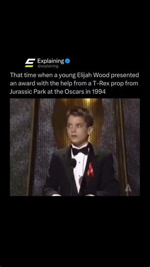 Explaining on Instagram: "At the 1994 Academy Awards, a young Elijah Wood stepped onstage to present the Oscar for Best Visual Effects. Midway through the moment, an enormous animatronic T-Rex head from Jurassic Park suddenly emerged from the wings, jaws wide open, and handed him the winner’s envelope. It was a perfectly timed gag for the film, which went on to win the award that night, making the dinosaur’s cameo one of the most memorable Oscar moments of the decade. 🦖🏆"