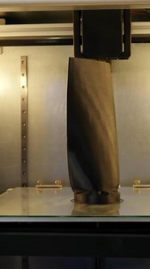 Automated technical 3d printer. Media. 3D printer creates tall object. Large automated 3d printer