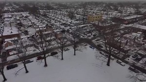 Drone shows aerial view of snow-covered New York neighborhood