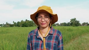 clip-1060184777-front-view-female-farmer-standing-paddy-field