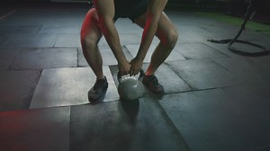 Muscular man exercising with a kettlebell - Free Stock Video