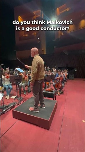John Malkovich steals Aleksey Igudesman's conducting baton... and starts conducting Ravel's Boléro.