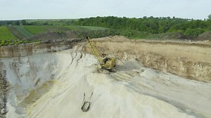 Sand Quarry For The Extraction Of Stone And Sand. A heavy machinery - excavator in the Sand Quarry