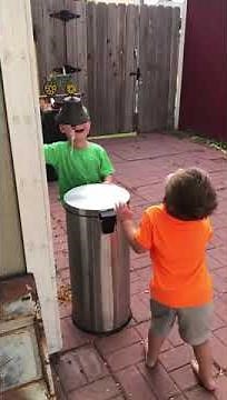 Kids Jokingly Hit Each Other With Trash Can's Lid by Stepping on It's Pedal - 1069518