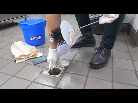 How to clean restaurant floor drains with a drain brush and sanitizer