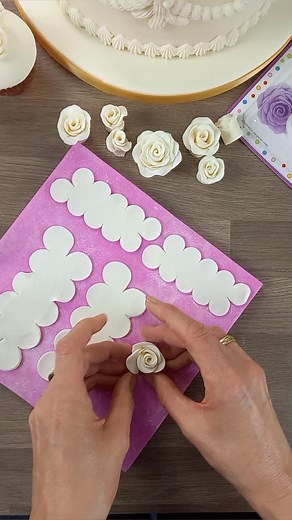 How to make sugar roses with the 'Easiest rose ever' cutter from FMM 🌹 Shop the cutter here - https://www.cakecraftworld.co.uk/fmm-the-easiest-rose-ever-cutter.html Top tips for making the roses: 1. Roll out the paste to 1-2mm, cut out the petals. 2. Place on foam pad and use a rolling pin to thin the edges - this makes a more delicate rose. 3. Brush edible glue along the petals and fold in half lengthways. 4. Turn over, brush over with glue and start to roll up. Roll rightly at the start to cr