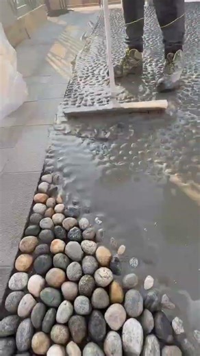 Brushing wet concrete to create a textured stone pattern #construction #work #popular #skills