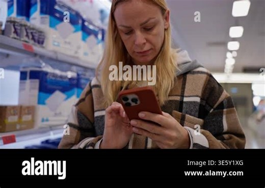 woman using phone at pharmacy Stock Video Footage - Alamy