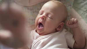 A slow motion of a yawning baby girl