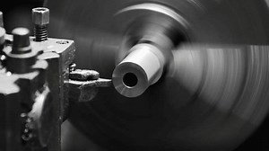 Process forming cylindrical workpieces with metal turning blade at high speed causing the workpiece rotate around itself with the turning blade moving towards workpiece smoothly and accurately.