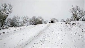 Snow Tuber Catches Air and Faceplants in Slow Motion