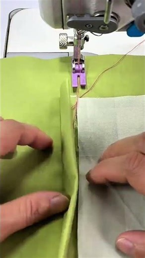sewing green fabric with a machine to create neat pockets for clothing and textiles