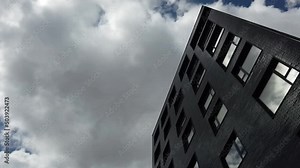 Exterior of a high-rise apartment building facade, windows and balconies.