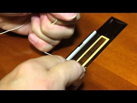 Changing guitar strings on a classical, nylon string guitar, or replacing a broken string
