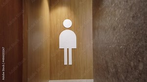 Toilet sign. A visitor to a modern shopping center approaches the toilet.