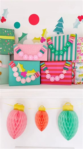 Kara Whitten - Kailo Chic on Instagram: "The cutest way to make your holiday gift wrapping special for cheap! Dollar store pool noodles, paper rounds, paint, and letter stickers are all you need! Christmas gift wrap ideas for swifties"