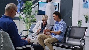Senior specialist measuring insulin level and glucose in blood sample to Chronic diabities patient during checkup using glucometer, consulting asian patient. Handheld shot of taking blood sample from