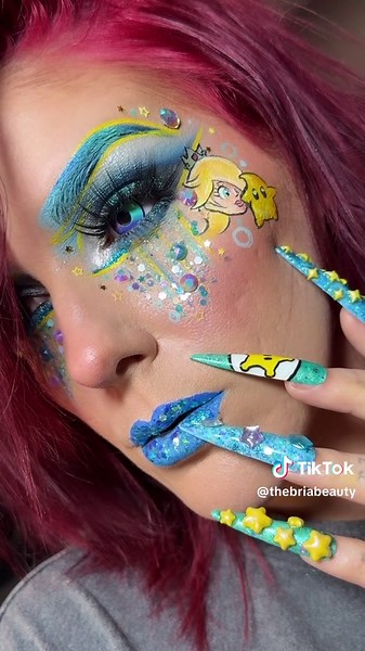🩵✨Rosalina✨🩵 My latest makeup/nails series, Mario characters! I did this series years ago but wanted to do a revised version to see how much growth has happened and to incorporate nails this time. 💅🏼 Who do you think will be next? 🤔 @Nintendo USA 🩵 @milkmakeup Hydro Grip Primer. ✨ @ColourPop Cosmetics Pretty Fresh Foundation. Blue Moon palette. “Power Trip” Chrome Creme Gel Liner. 🩵 @Juvia’s Place I Am Magic Concealer. ✨ @ONE SIZE BEAUTY Ultimate Blurring Setting Powder. 🩵 @Benefit Cosme