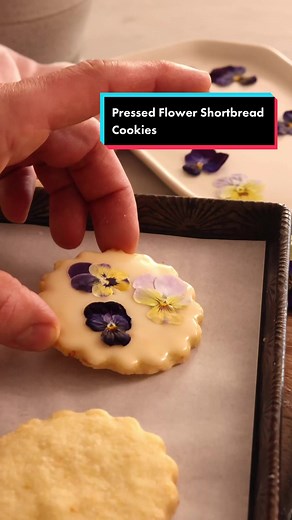 These Amazing Pressed Flower Shortbread Cookies packed full of orange flavor will melt in your mouth and dazzle the eye. Beautiful edible flowers get pressed and decorate the tops for a show-stopping reminder of summer’s fleeting bounty. The recipe is only in my book so grab a copy from, Barnes and Noble, Amazon, or your favorite bookstore! #preppykitchen #recipevideo #baker #foryou #cookies