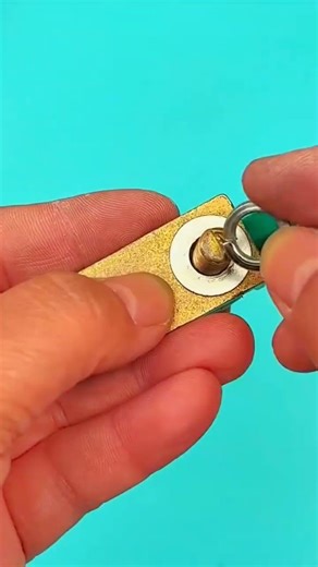 Pliers clamp wire—hand holds rhythm of strand, brass, and terminal bonds true with crafted precision