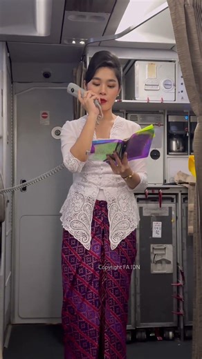 Beautiful flight attendant making an announcement
