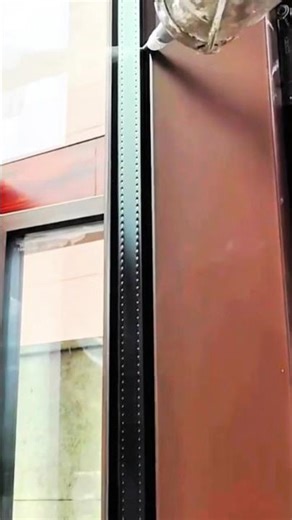 Mounting large digital screen securely on building facade