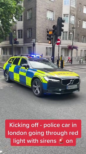 Police Car in London Running Red Light with Sirens
