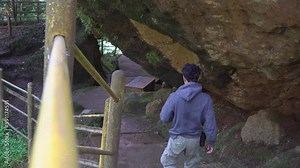 Man walking on the cave that popular travel destination on Semarang Central Java. The photo is suitable to use for adventure content media, nature poster and forest background.