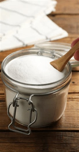 clip-4153858893-woman-taking-baking-soda-spoon-wooden-table