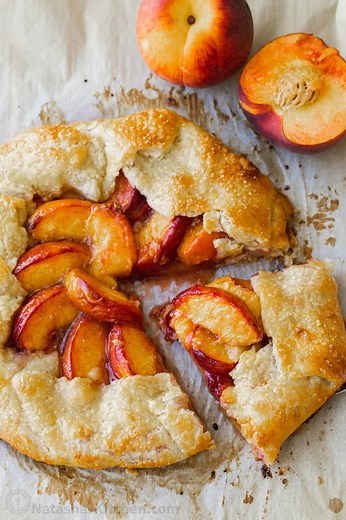 This Peach Galette recipe is perfect in every way, with a buttery, flaky crust and juicy cinnamon-dusted peaches. RECIPE: https://natashaskitchen.com/peach-galette-recipe/ | NatashasKitchen.com