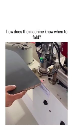 FUN TIME on Instagram: "The post showcases a 28-second video of an automated carton-folding machine using laser-guided sensors to precisely crease and fold pre-scored cardboard along marked lines, with the caption questioning the detection mechanism. Optical sensors, visible as green lights and a red laser in the footage, scan for fold indicators or use computer vision to align movements, drawing from industrial automation techniques that reduce errors by up to 95% per studies on packaging robot