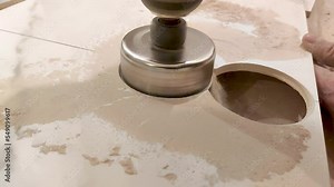 Drilling hole in ceramic tile with foraminifera.