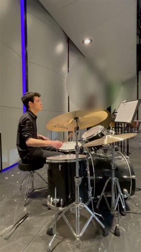 DRUMMER AND CONCERT BAND PLAY INTENSE GROOVE DURING CHARLIE BROWN CONCERT BAND PIECE