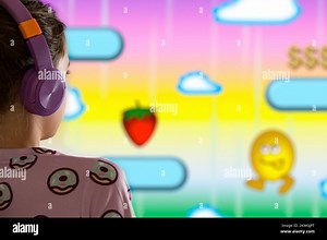 A child or teenager is playing computer video games on a large screen. Online video game technology and teen gaming addiction Stock Photo - Alamy