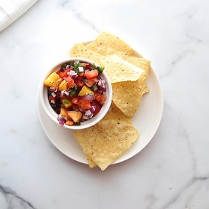 Fresh peach salsa is delicious with chips, on top of fish or pork, or spooned over tacos! You'll love the flavor combinations in this recipe!! https://lilluna.com/peach-salsa/ | Lil' Luna - Kristyn Merkley