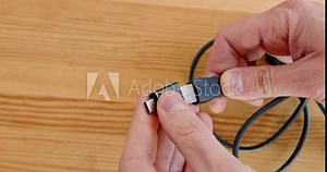 Close-up, using adapters to connect a cable to a digital device. Universal adapter to USB Type-C.