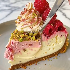 30K views · 326 reactions | Creamy, zesty, and stunning! This lemon raspberry cheesecake topped with pistachio crumb is pure elegance—perfect for any celebration or cozy dessert night.  #CheesecakeRecipe #LemonDessert #BakingInspiration | Optimal Recipes | Facebook
