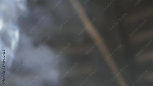 Central American woman finishes stirring a rice dish being cooked over an open fire and the camera rises up with the smoke.