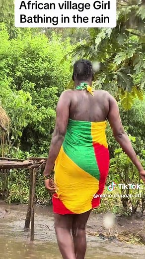 African Village Girl Enjoying Rain Shower