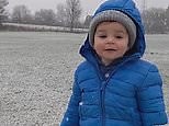 Adorable moment toddler wowed by seeing snow fall for the first time