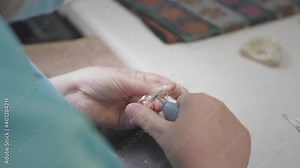 Adult female medic creates invisible braces in the laboratory. The surgeon holds the Invisalign removable in his hands. Advanced technology in dentistry. Production of artificial teeth