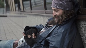 Homeless man scrolling on his phone - Free Stock Video