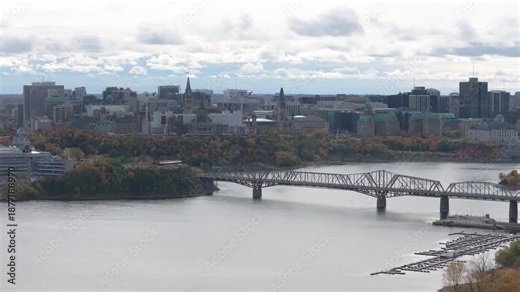 Cinematic drone shot of the historic Alexandra Bridge steel truss structure spanning the Ottawa River between Ottawa and Gatineau.