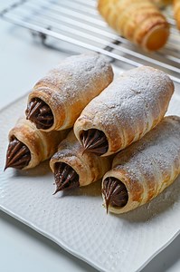 Try DLA's chocolaty and creamy cornet pies. Full recipe below Chocolate Cornet Pies: Ingredients: Chocolate Custard Cream: - DLA El Pao 58% Dark Chocolate Couverture 50g - 2 egg yolks - 200g milk - cake flour 20g - granulated sugar 40g - egg wash (small amount of water and an egg yolk) - Powdered sugar (for dusting) - Puff pastry (11x18cm) 2 sheets Preparation: - lightly oil or grease the cornet molder Method: 1. Make chocolate custard cream. Put egg yolks and granulated sugar in a bowl and mix 