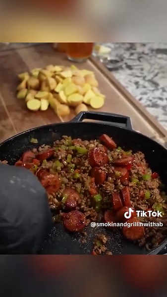 Y’all, these Dirty Smothered Potatoes are calling your name! This is the kind of comfort food you make room for on your plate. What are you serving with yours? Get the full recipe at smokinandgrillinwitab.com. #SmokinAndGrillinWithAB #DirtySmotheredPotatoes #SmotheredPotatoes #SouthernCooking #ComfortFood